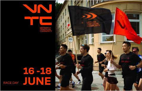 Triathlon athletes running with VNTC flags in Da Nang