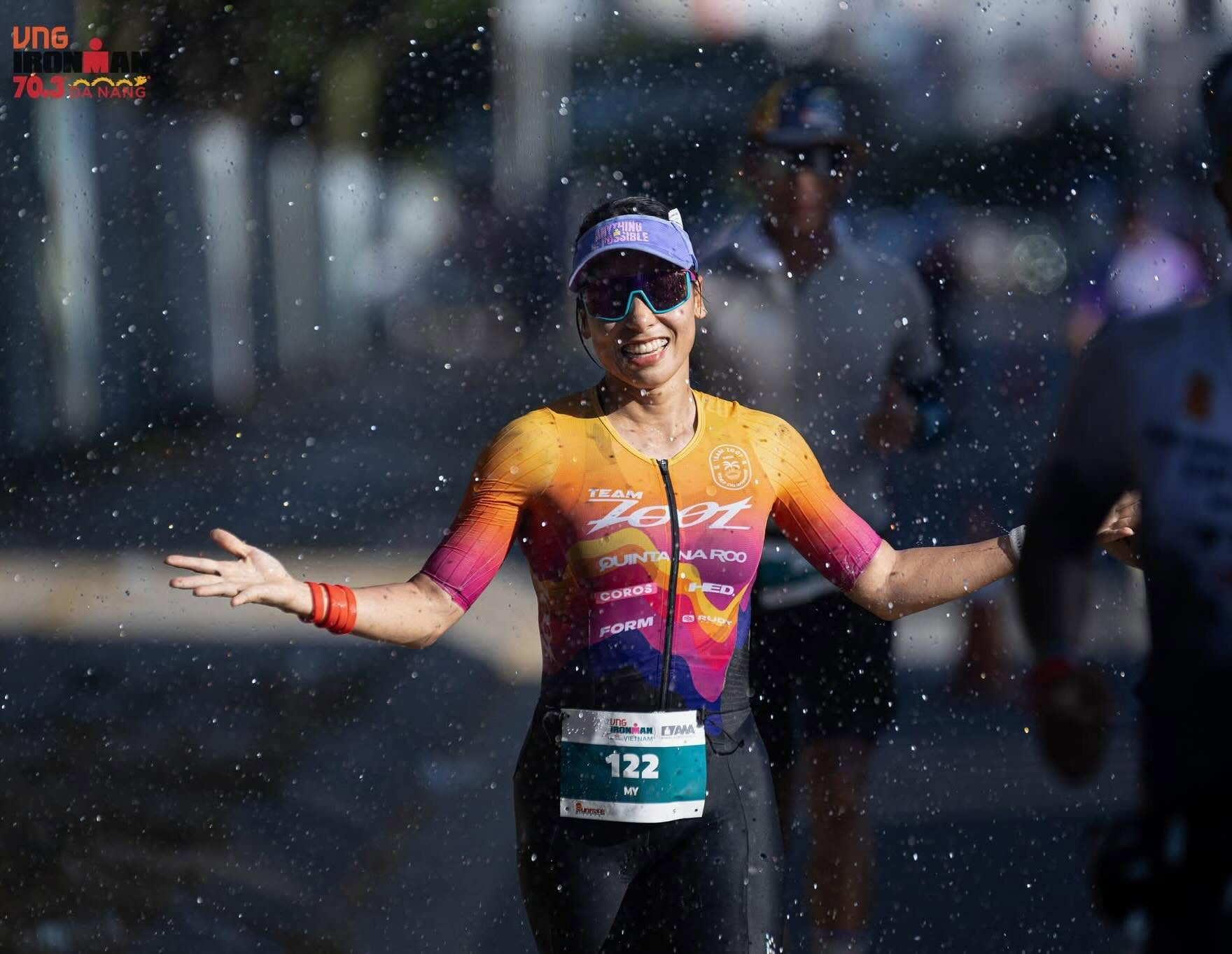 Female triathlete crossing finish line
