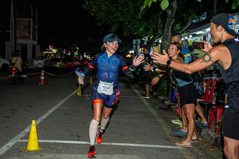 Marathon runner celebrating with crowd