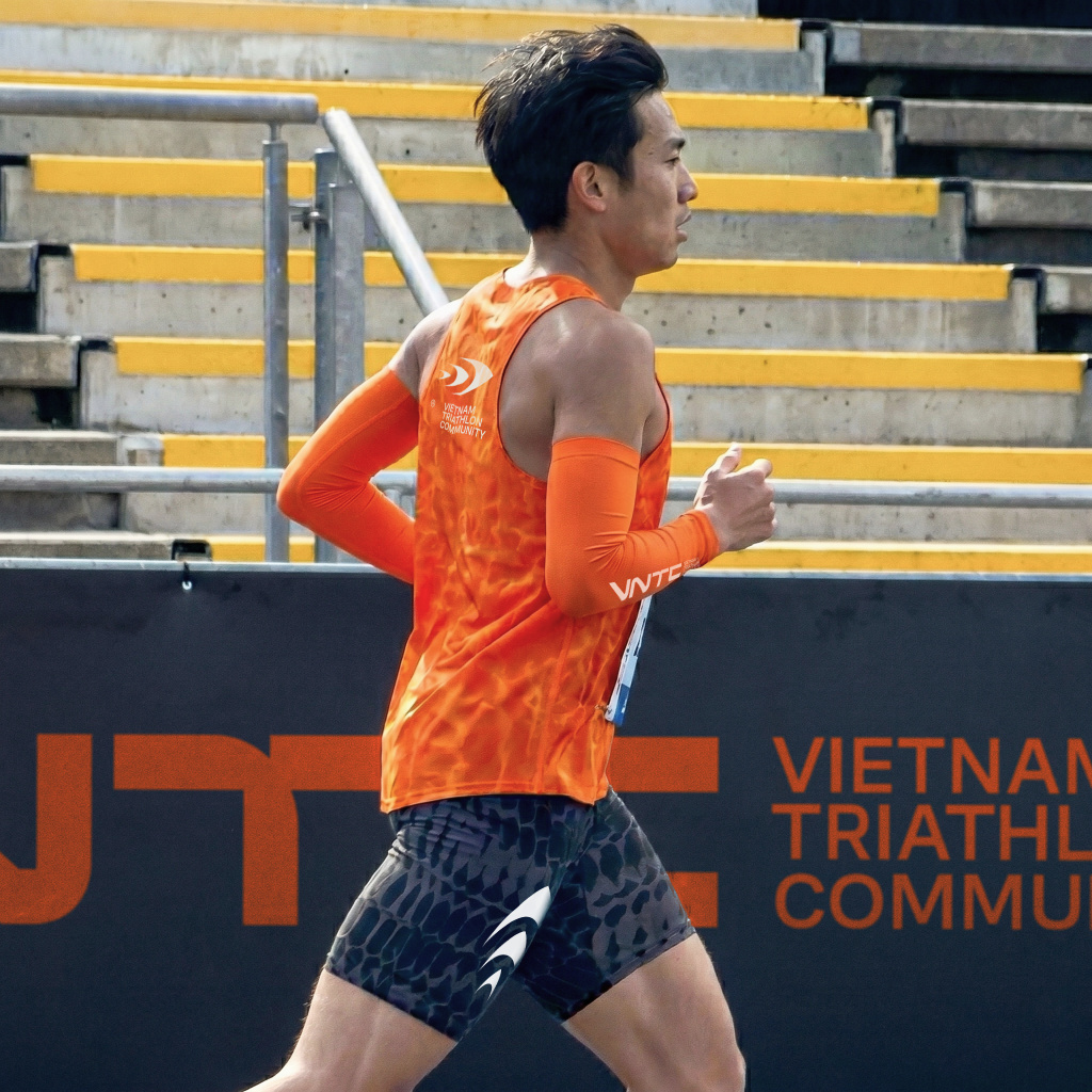 Triathlete in orange jersey running